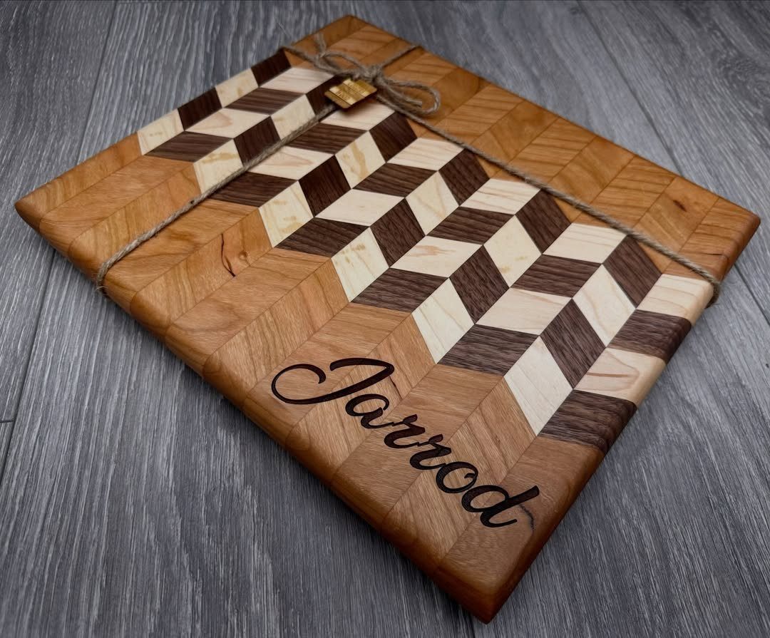 Wooden cutting board with checkered pattern and the name Jarrod engraved in cursive.