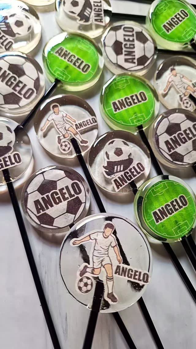 Soccer themed lollipops with soccer balls and players featuring the name Angelo.