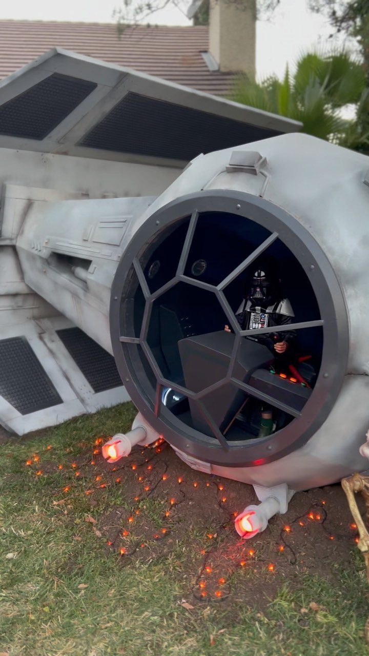 TIE Fighter cockpit prop on grass with Darth Vader sitting inside the cockpit
