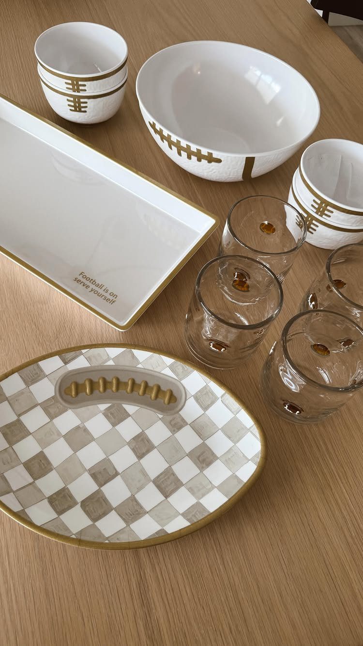 Football themed tableware including bowls and trays with yard lines on wooden table
