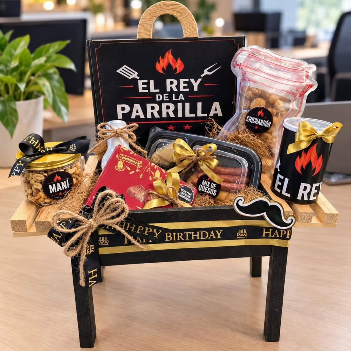 BBQ themed gift basket in a grill-shaped container with snacks and grilling accessories