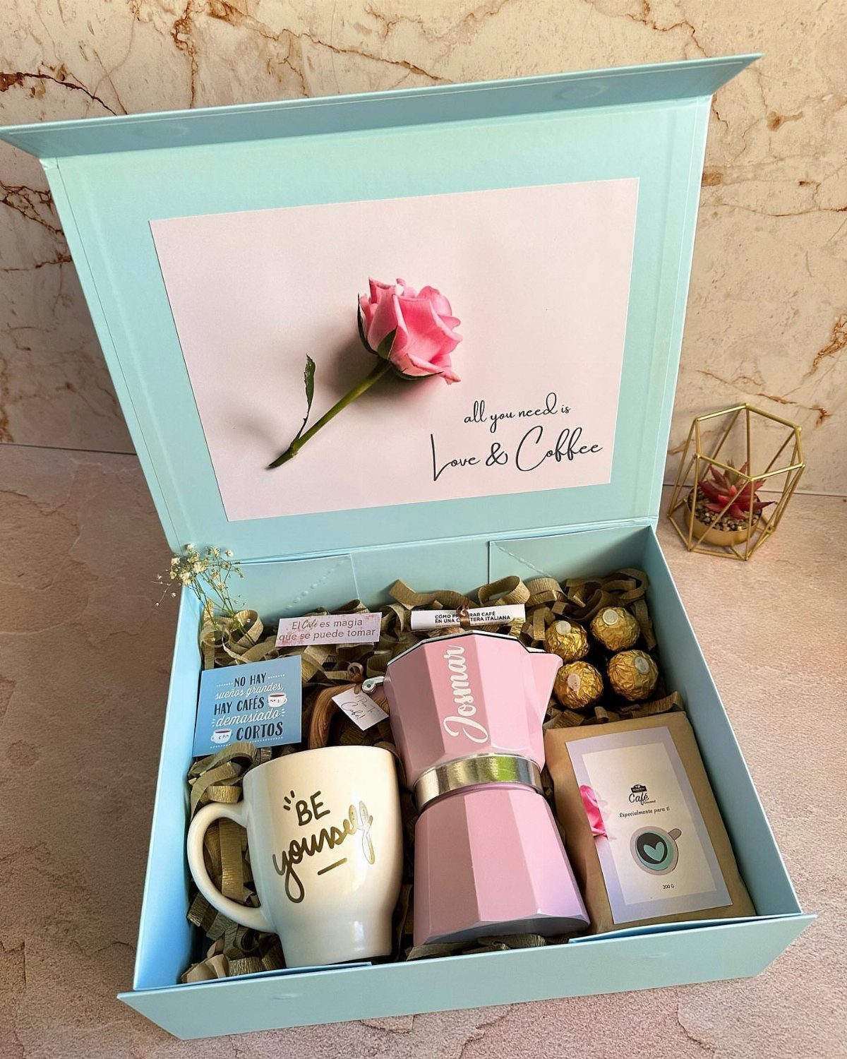 Coffee gift box with a white mug, pink coffee maker, and a pink rose.