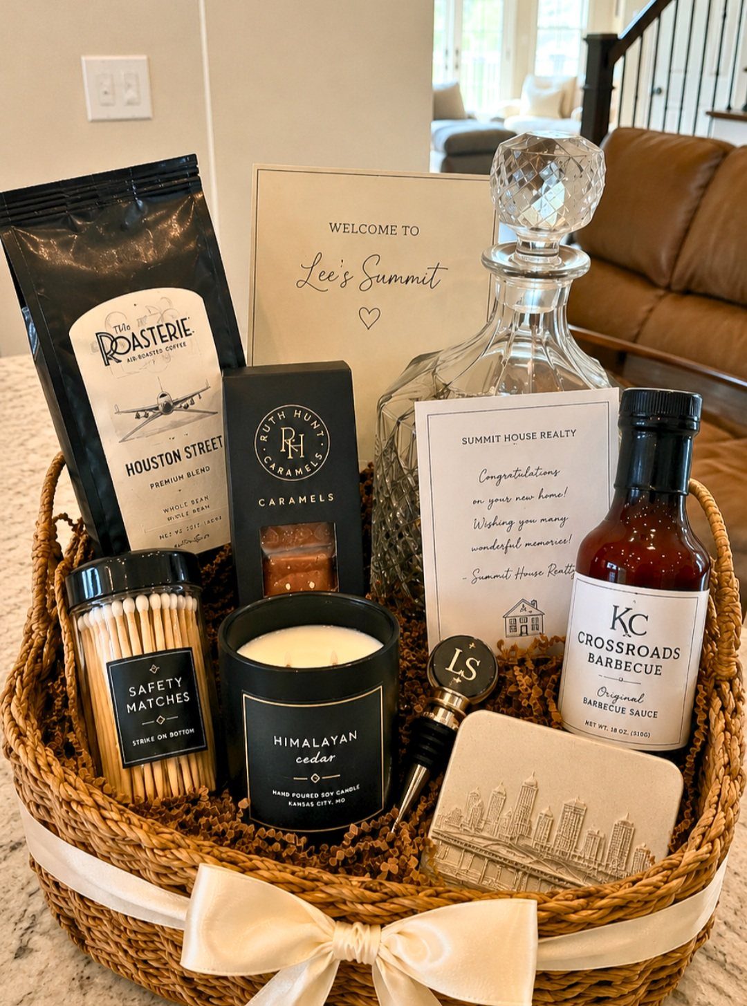Woven gift basket containing local coffee, barbecue sauce, caramels, and a welcome card.
