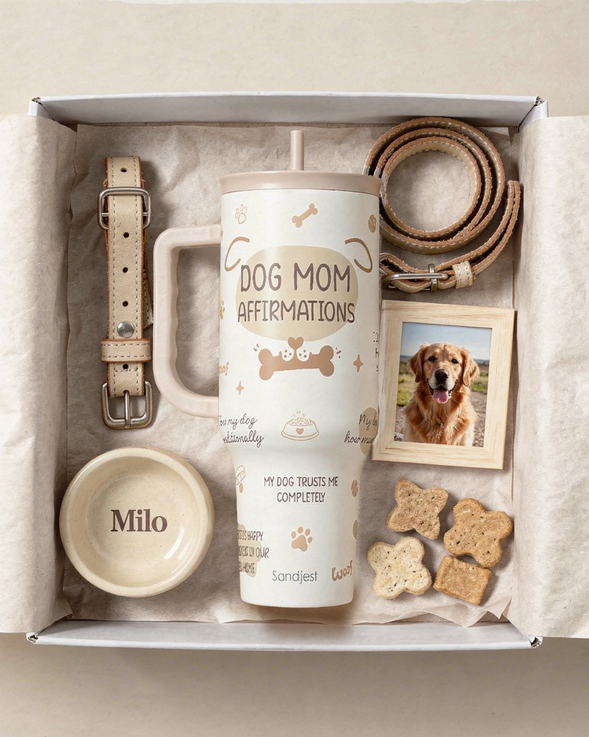 Pet parent gift box with dog mom tumbler, leash, treats, and dog photo.