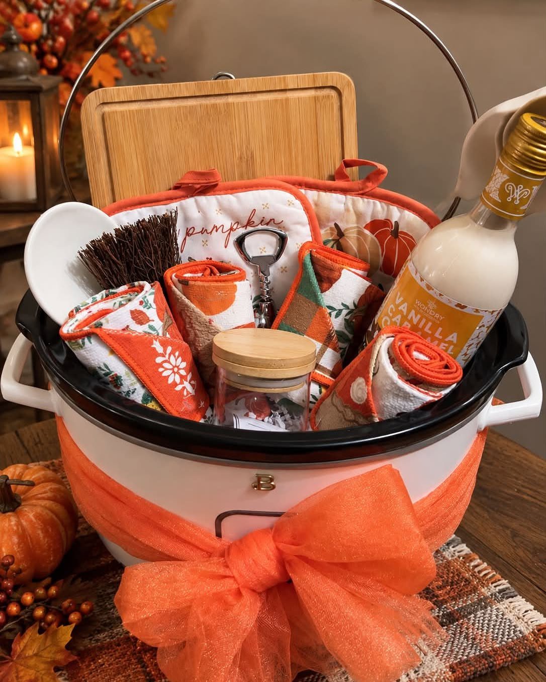Pumpkin themed gift basket inside a white slow cooker with orange tulle bow