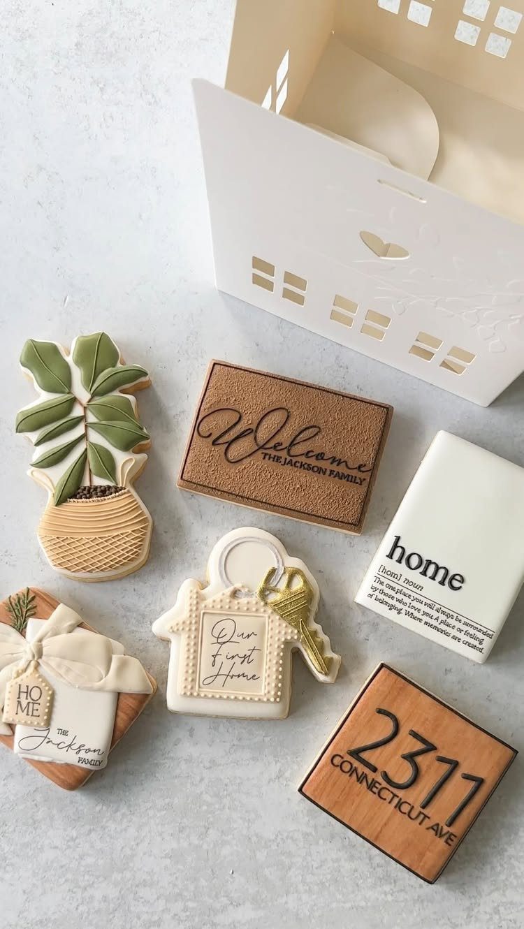 Housewarming themed sugar cookies shaped like a plant, welcome mat, and a house.