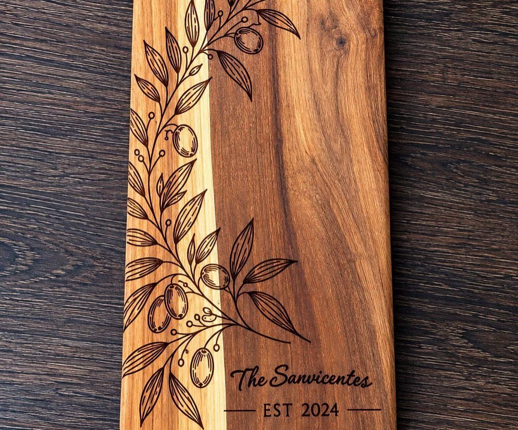Engraved wooden cutting board with olive branches and personalized family name and date.